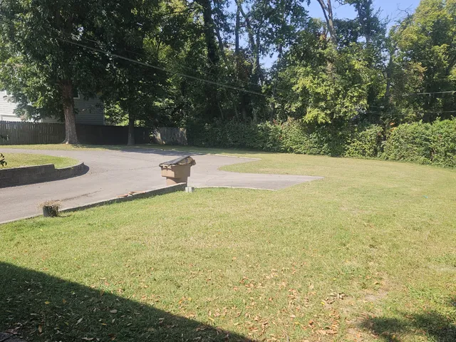 a view of a swimming pool with a yard