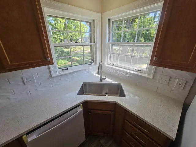 a kitchen with a sink and large window