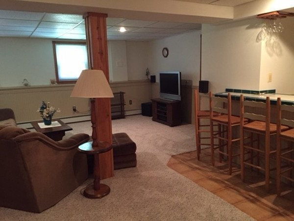 17 Virginia Road Tyngsborough, MA 01879 - Photo 10 of 19 a living room with furniture a flat screen tv and a large window