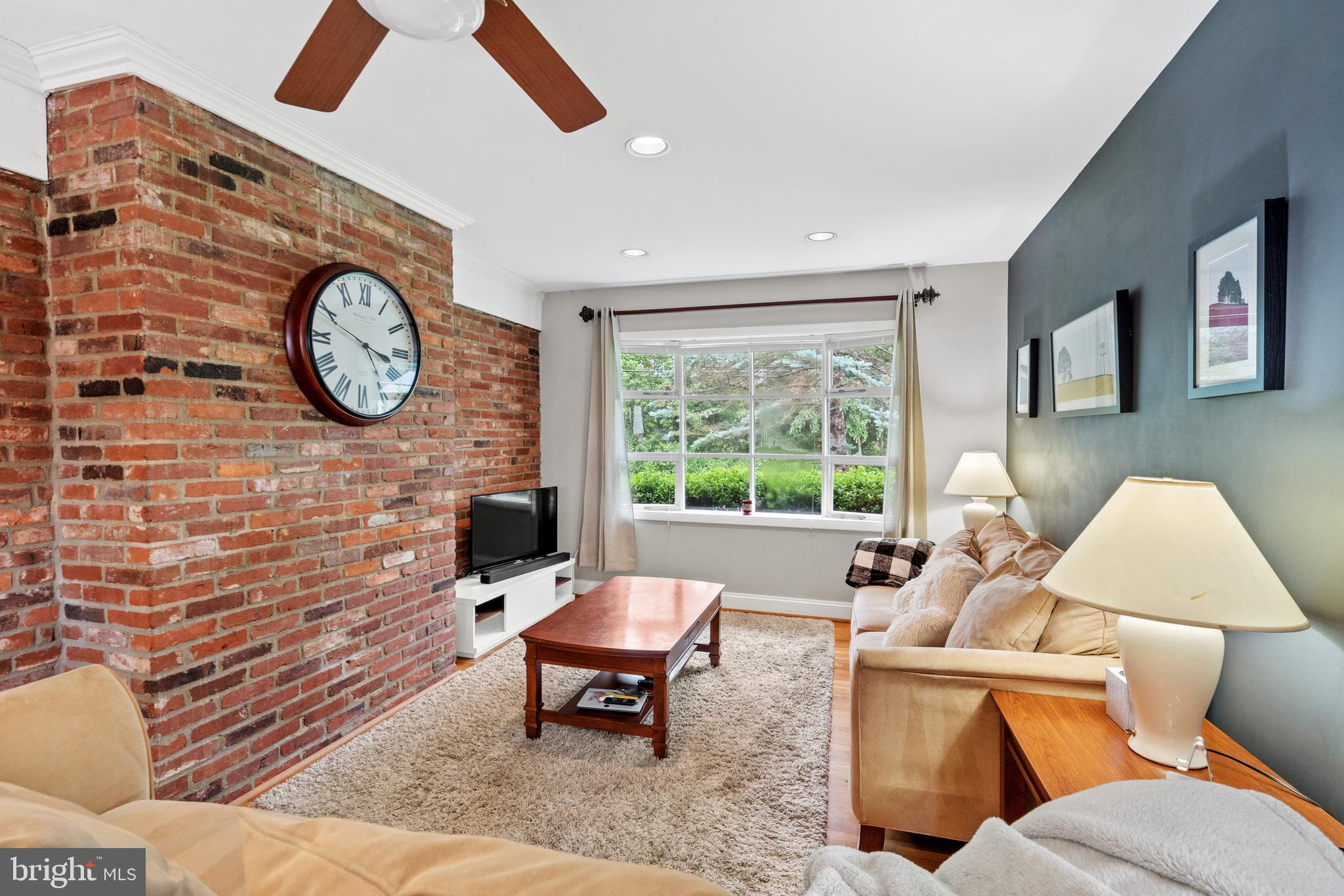 6823 Churchill Road McLean, VA 22101 - Photo 18 of 40 a living room with furniture a rug and a wall painting