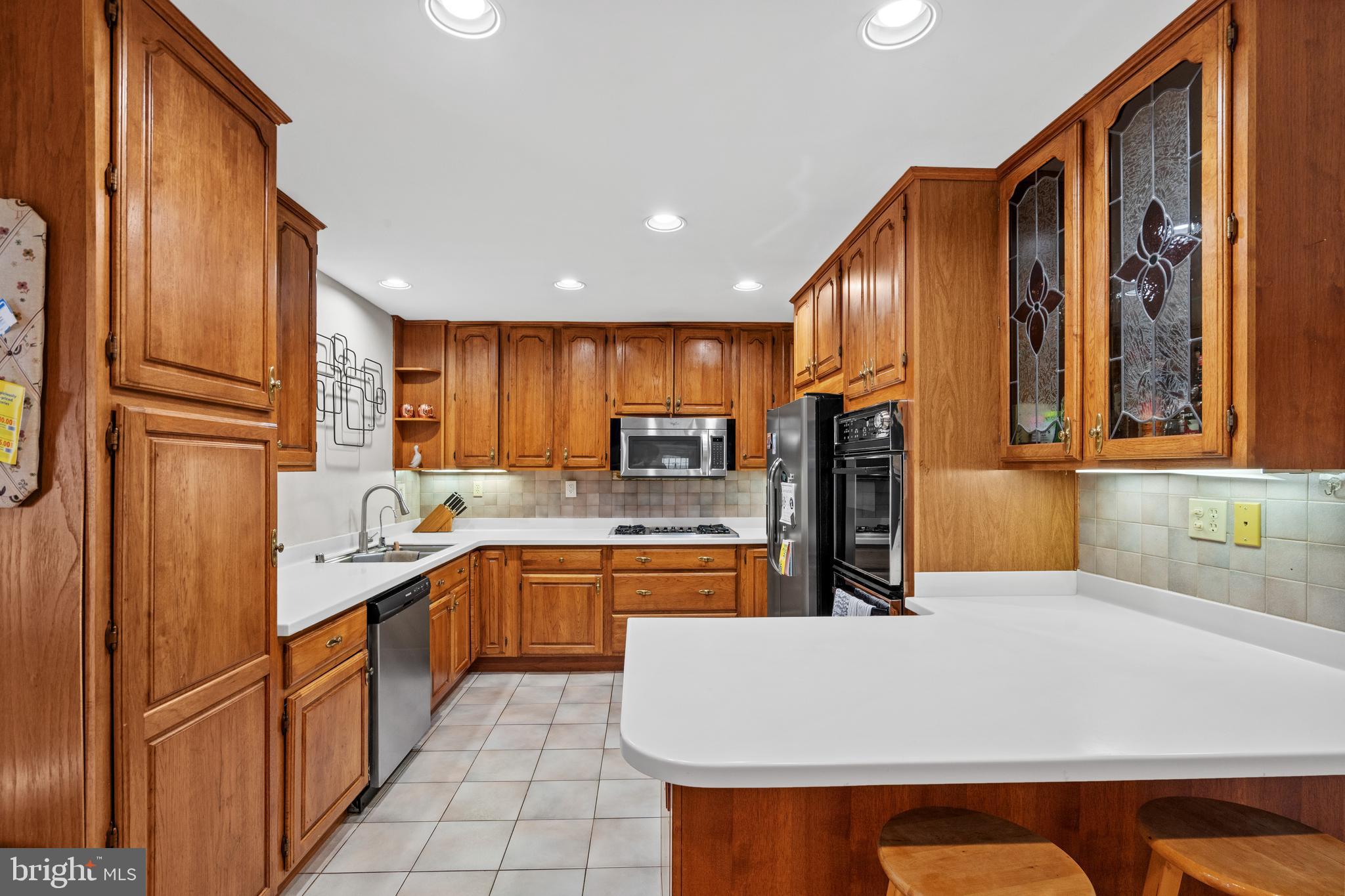 6823 Churchill Road McLean, VA 22101 - Photo 20 of 40 a kitchen with stainless steel appliances granite countertop a refrigerator and a sink