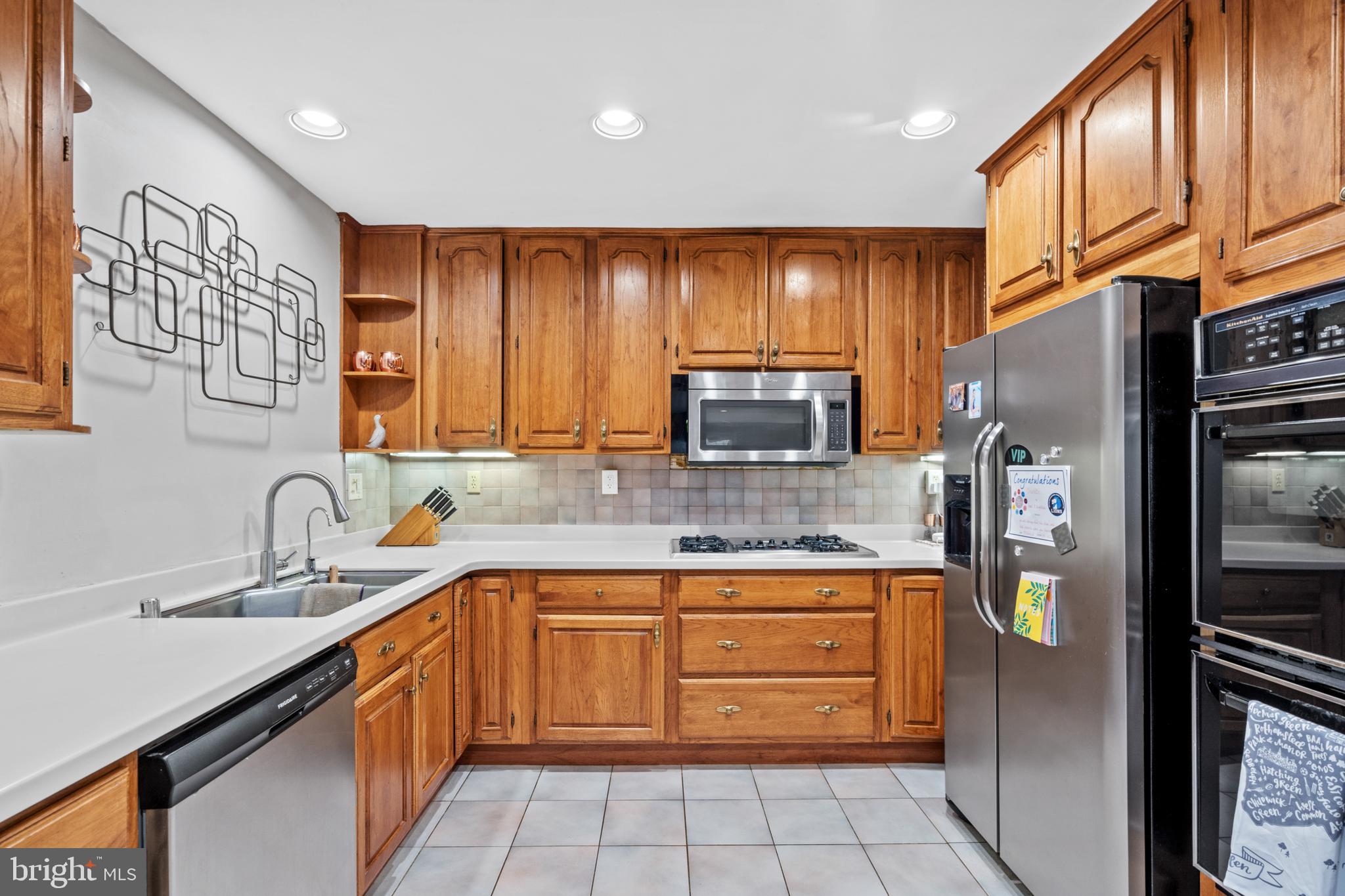 6823 Churchill Road McLean, VA 22101 - Photo 21 of 40 a kitchen with a refrigerator sink and cabinets