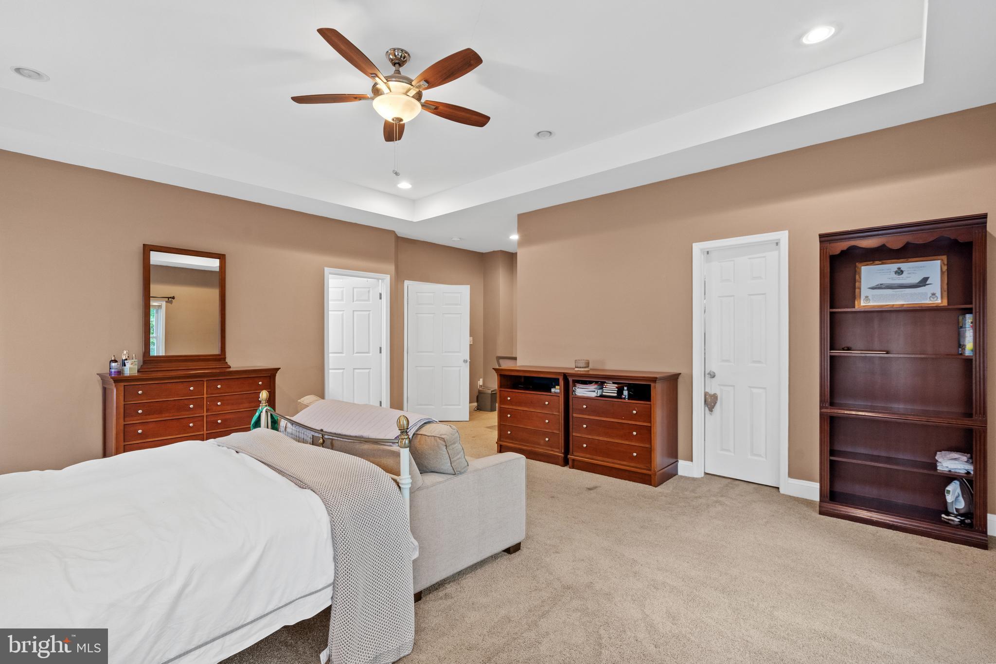 6823 Churchill Road McLean, VA 22101 - Photo 27 of 40 a bedroom with a bed and a chandelier