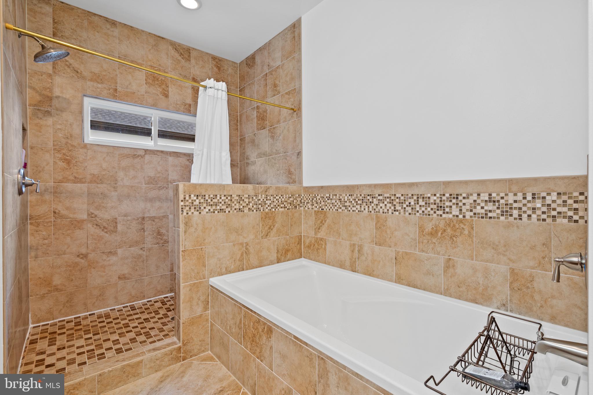 6823 Churchill Road McLean, VA 22101 - Photo 28 of 40 a bathroom with a bathtub and shower