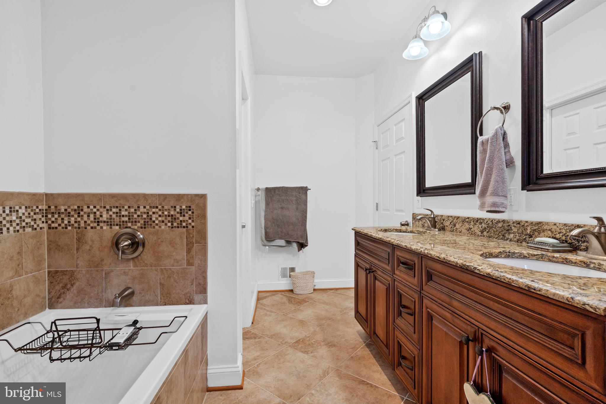 6823 Churchill Road McLean, VA 22101 - Photo 29 of 40 a spacious bathroom with a sink and a mirror