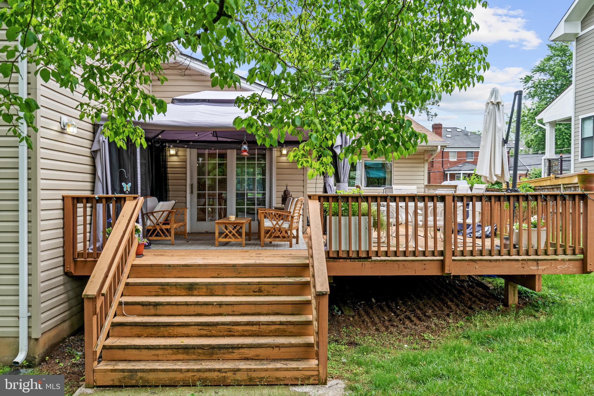 6823 Churchill Road McLean, VA 22101 - Photo 10 of 40 a view of a house with wooden deck and furniture