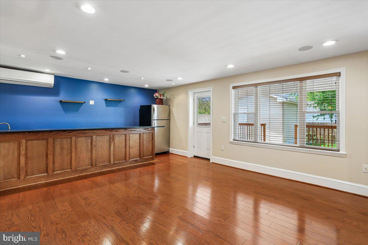 3709 Kenway Street Silver Spring, MD 20906 - Photo 11 of 34 a view of an empty room with a window and wooden floor