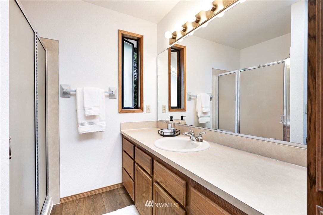 13024 Northeast 184th Place Bothell, WA 98011 - Photo 11 of 27 a bathroom with a sink and a mirror