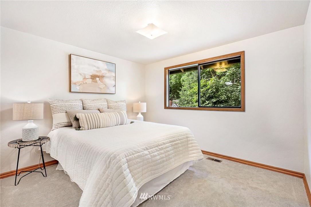 13024 Northeast 184th Place Bothell, WA 98011 - Photo 12 of 27 a bedroom with a bed and a window