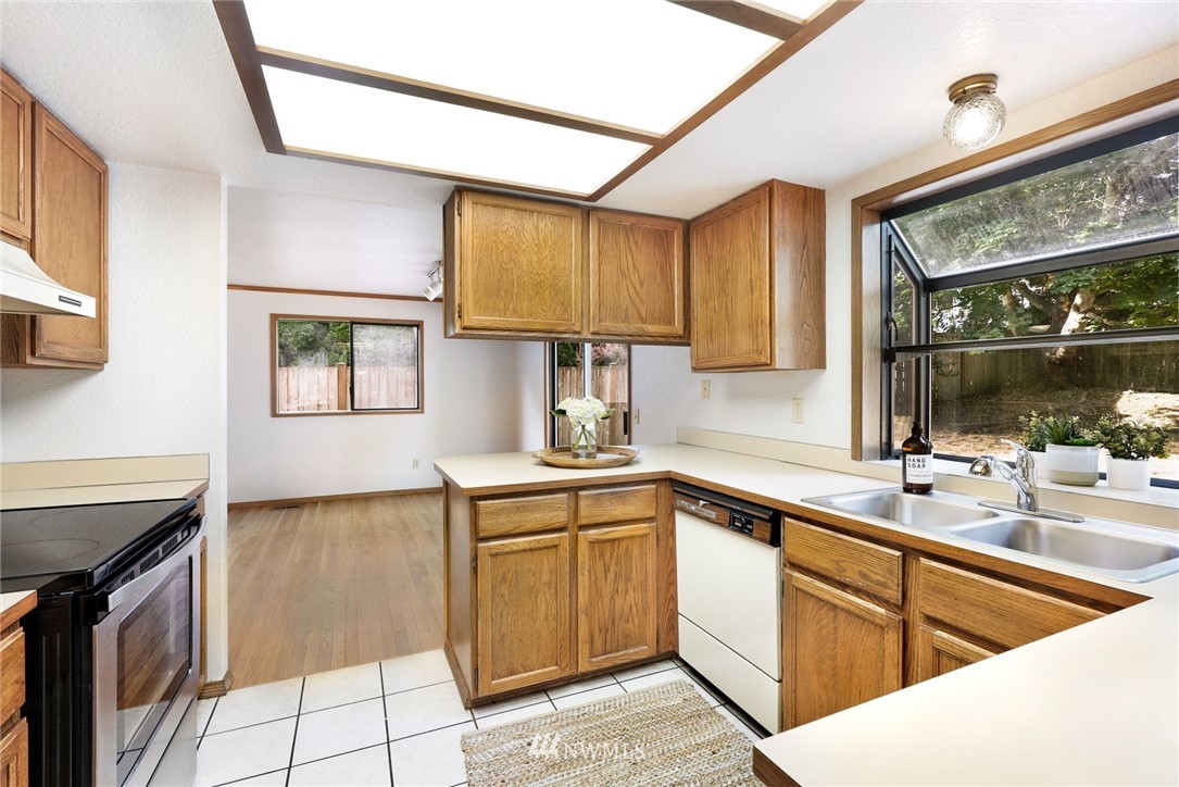 13024 Northeast 184th Place Bothell, WA 98011 - Photo 6 of 27 a kitchen with a sink stove and cabinets