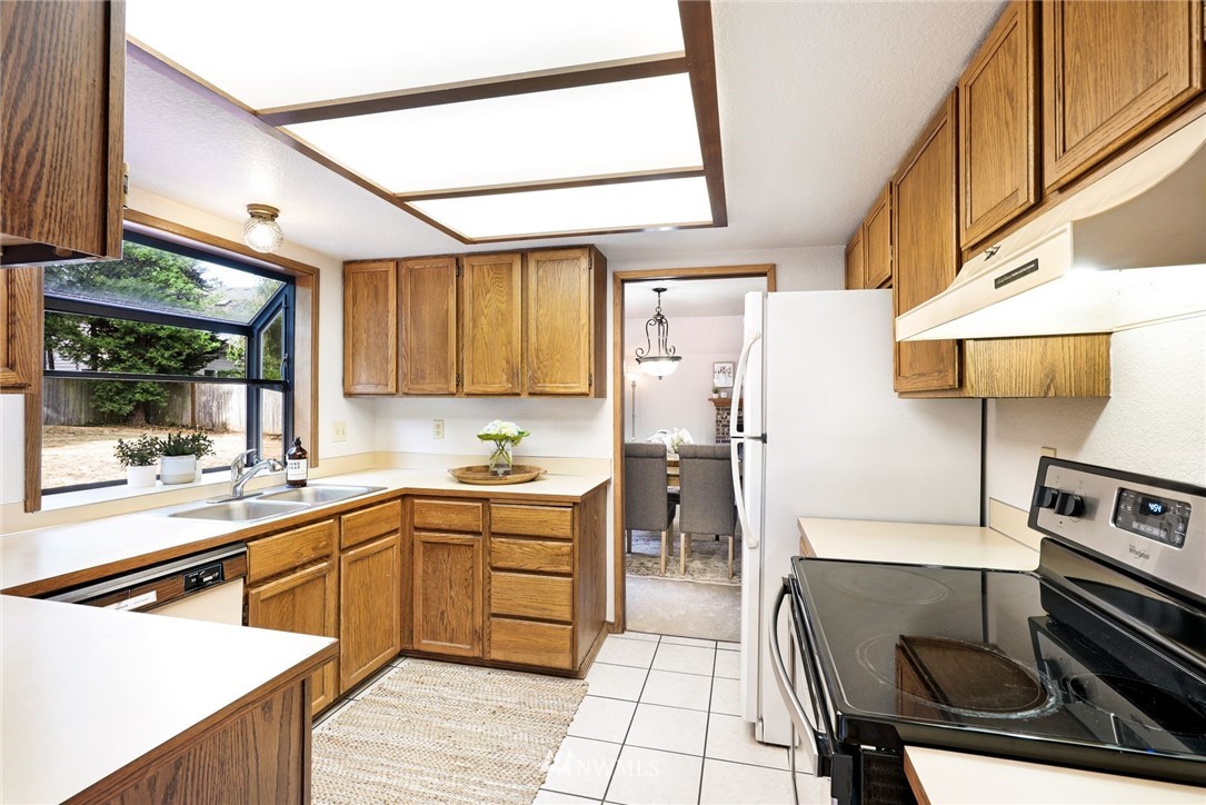 13024 Northeast 184th Place Bothell, WA 98011 - Photo 7 of 27 a kitchen with stainless steel appliances granite countertop a sink and a stove