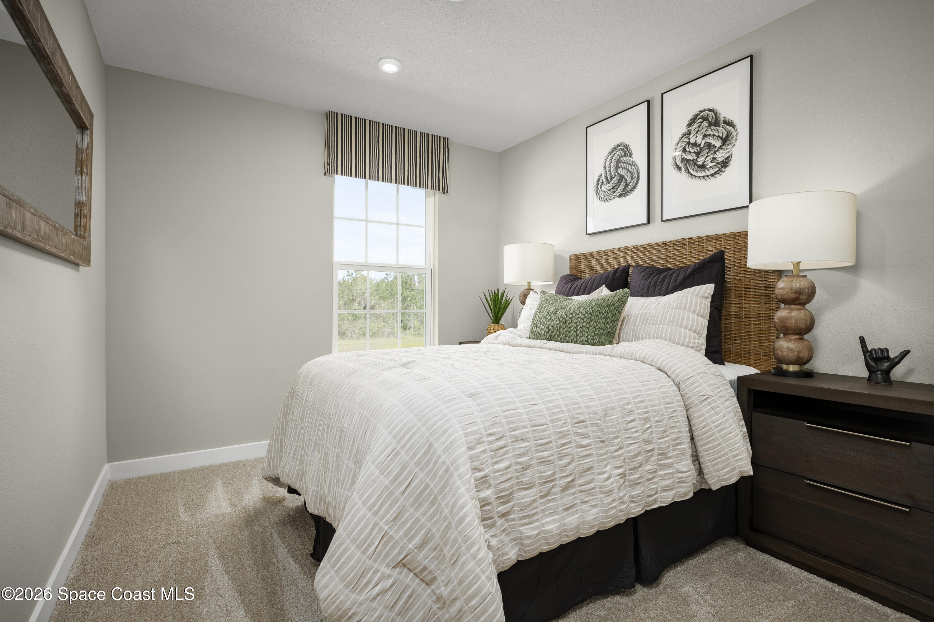 1758 Kendall Pointe Place Melbourne, FL 32935 - Photo 12 of 15 a bedroom with a bed and window