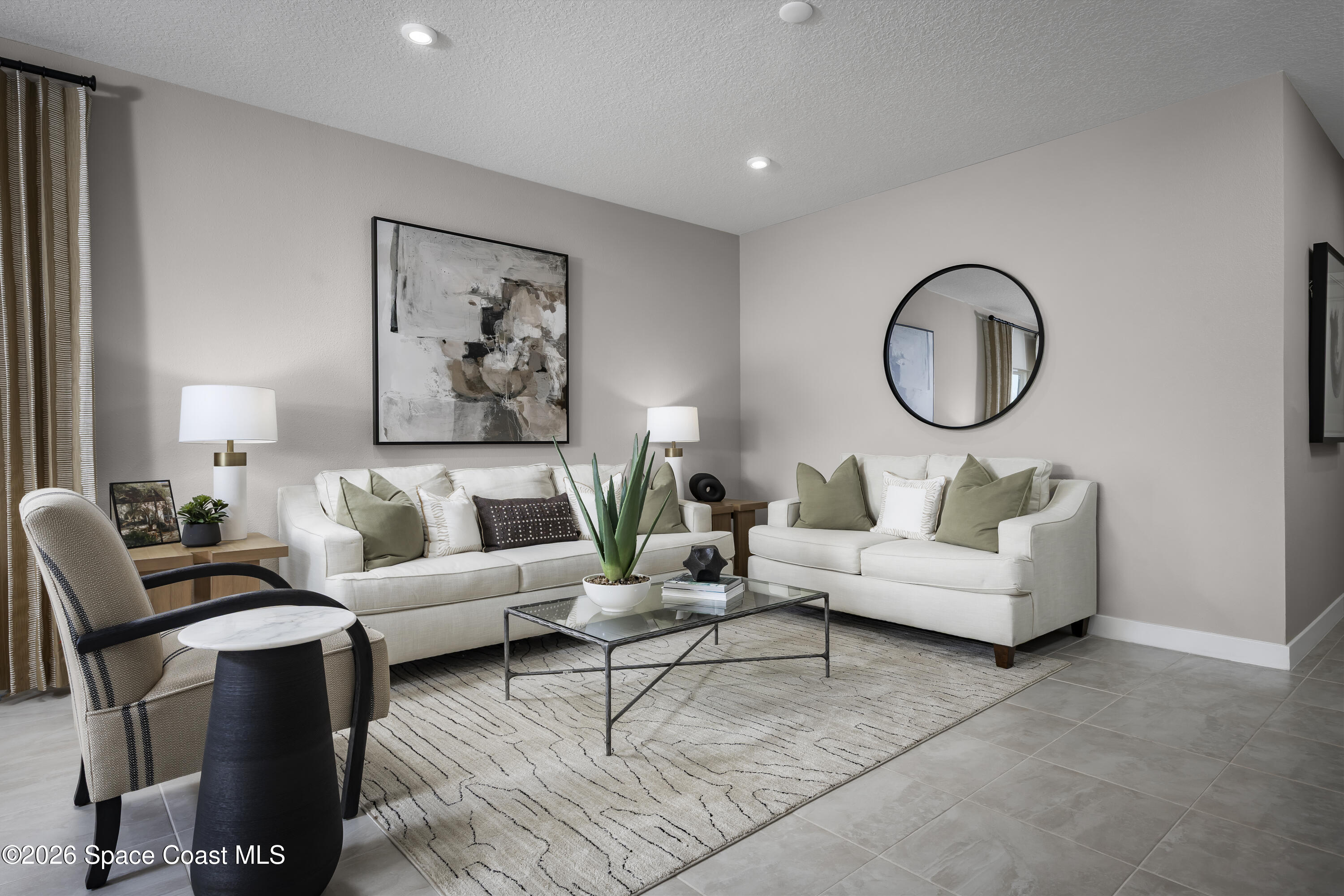 1758 Kendall Pointe Place Melbourne, FL 32935 - Photo 2 of 15 a living room with furniture a white walls and a large window