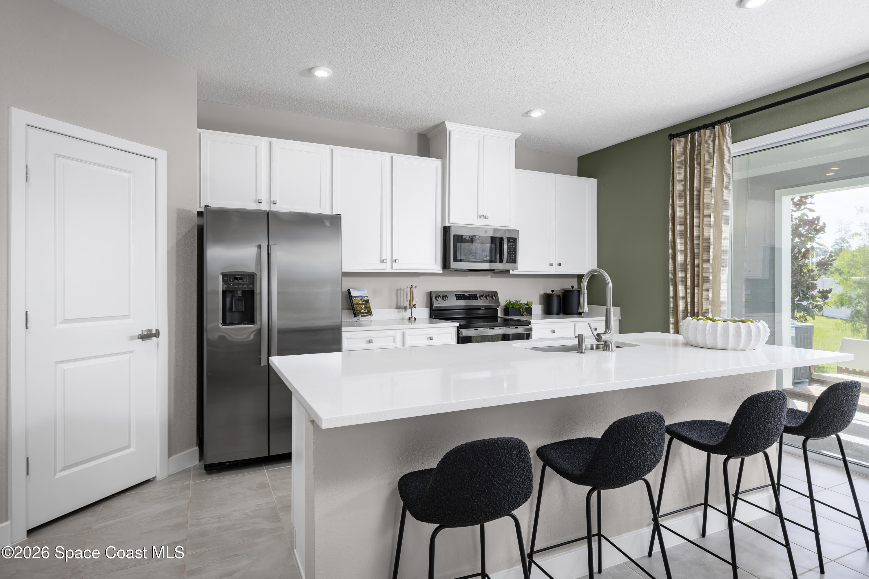 1758 Kendall Pointe Place Melbourne, FL 32935 - Photo 8 of 15 a kitchen with appliances a sink and cabinets