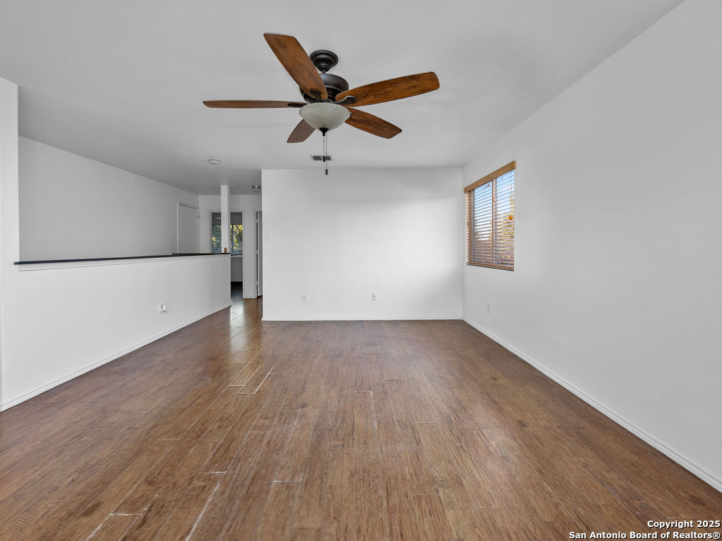 11031 Rindle Ranch San Antonio, TX 78249 - Photo 21 of 45 a view of a livingroom with a ceiling fan and wooden floor