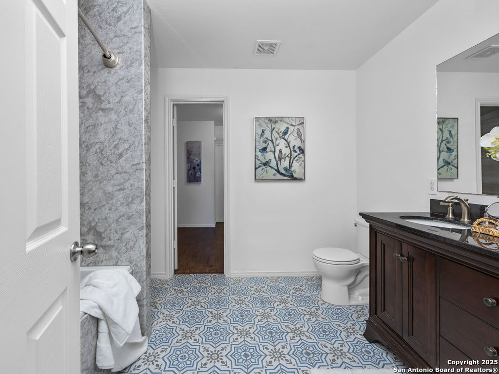 11031 Rindle Ranch San Antonio, TX 78249 - Photo 29 of 45 a bathroom with a sink toilet and shower