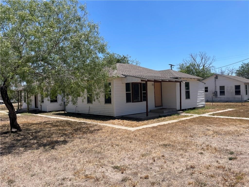 303 East Hackberry Street Mathis, TX 78368 - Photo 2 of 13 a view of a house with a yard and large tree