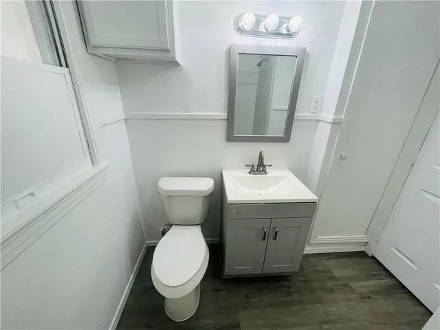 a bathroom with a sink toilet and mirror
