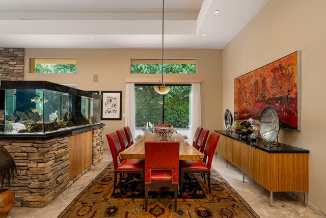 a dining room with furniture a rug and a chandelier
