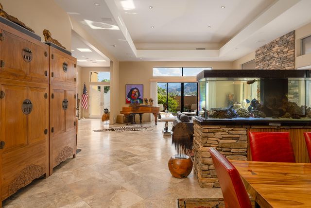 a living room with furniture a flat screen tv and a view of kitchen
