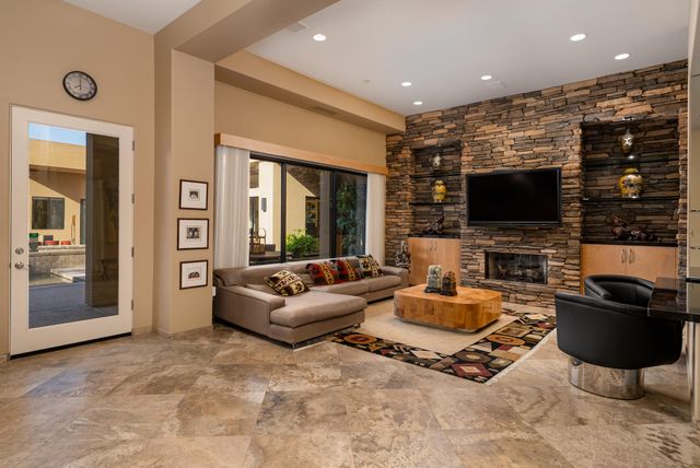 a living room with fireplace furniture and a flat screen tv
