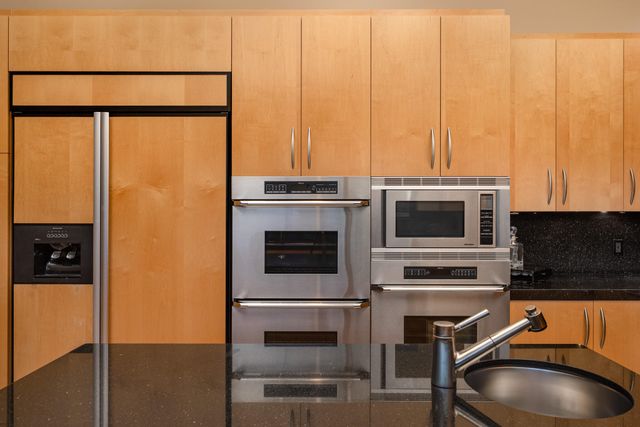 a spacious bedroom with a bed and a flat screen television