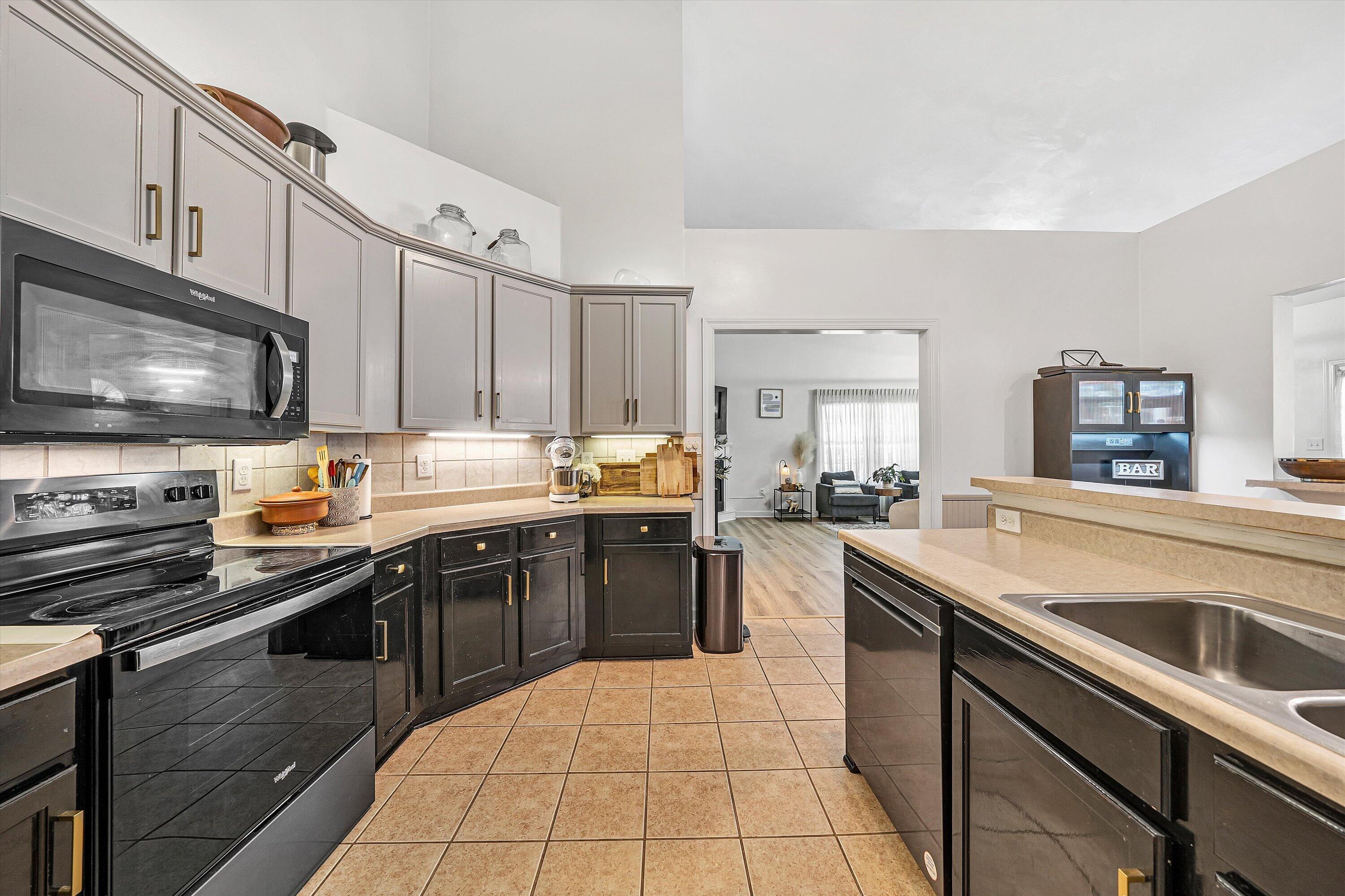 5424 Quail Ridge Court Roanoke, VA 24018 - Photo 16 of 41 a kitchen with stainless steel appliances a sink dishwasher stove top oven refrigerator and cabinets