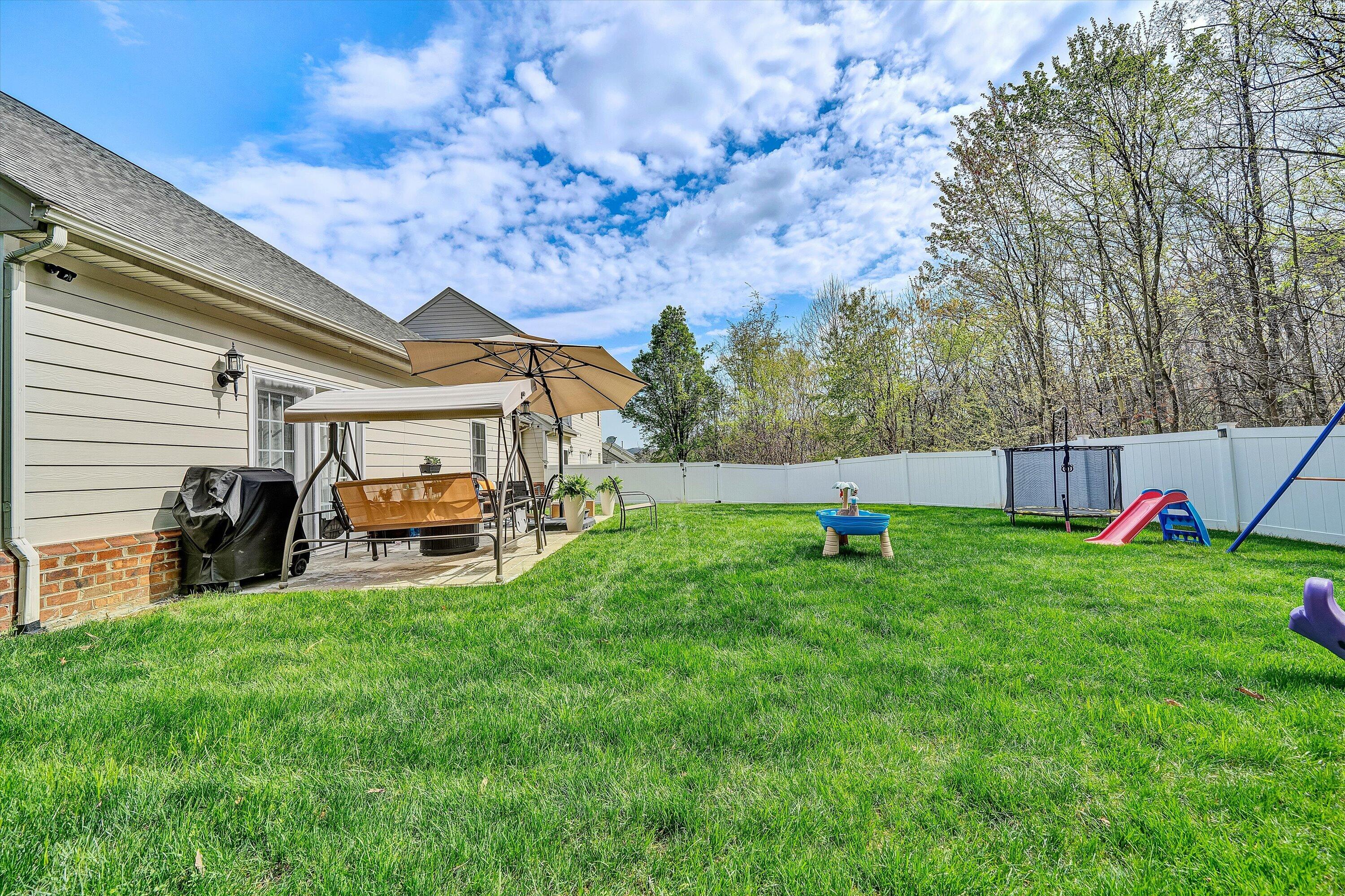 5424 Quail Ridge Court Roanoke, VA 24018 - Photo 36 of 41 a view of a backyard with table and chairs and a slide