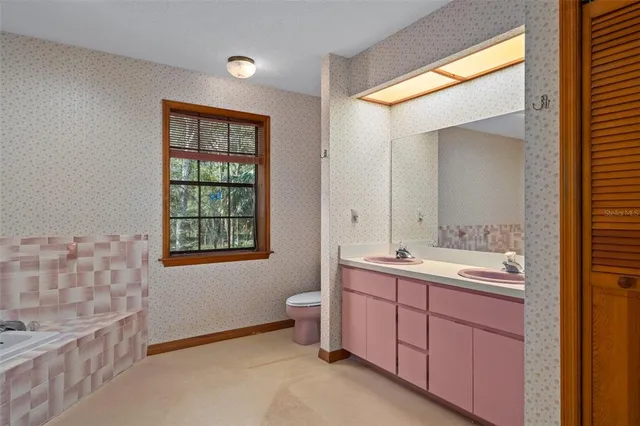 a view of a house with backyard and chairs