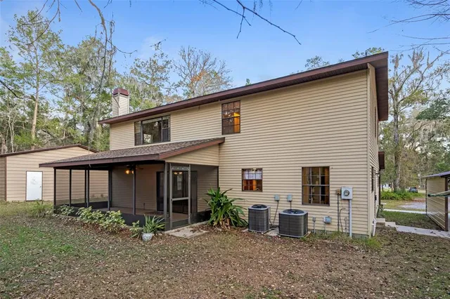 a backyard of a house with a yard and trampoline