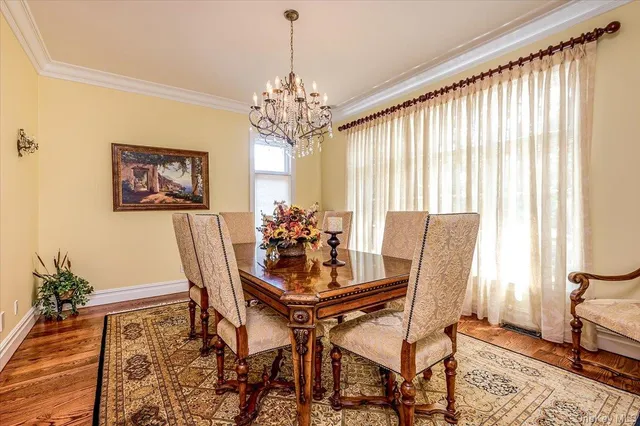 a view of a dining room with furniture and chandelier