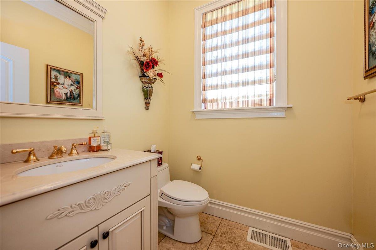 83 Ithaca Avenue Atlantic Beach, NY 11509 - Photo 18 of 45 Half bath featuring vanity and tile patterned floors