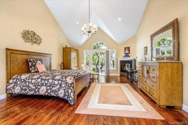 a bedroom with a large bed and a chandelier