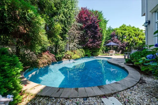 a view of a backyard with sitting area