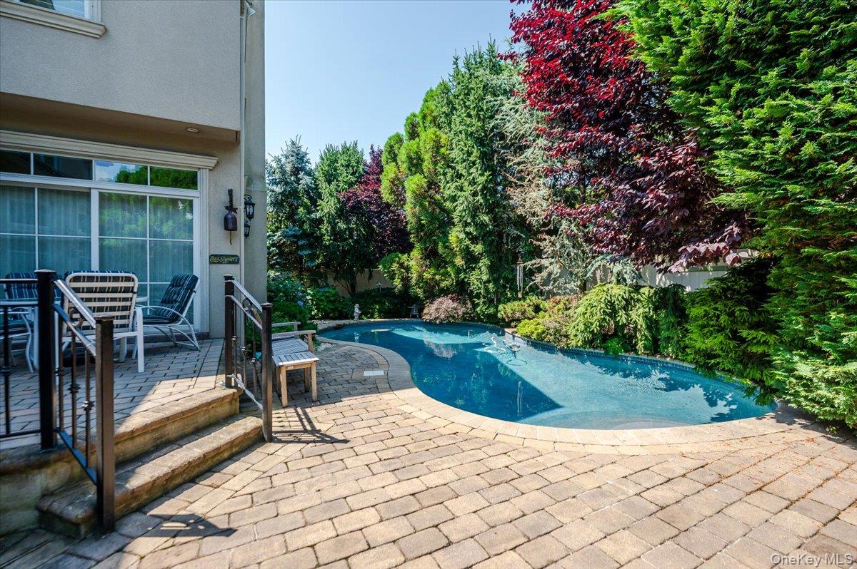 83 Ithaca Avenue Atlantic Beach, NY 11509 - Photo 39 of 45 Swimming pool, patio and outdoor dining area