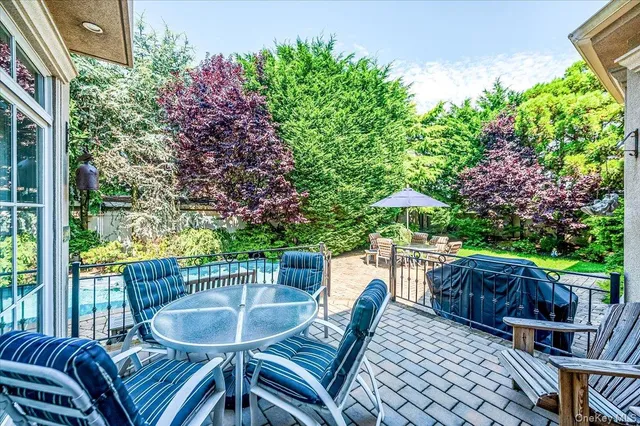 a view of a patio with a table and chairs