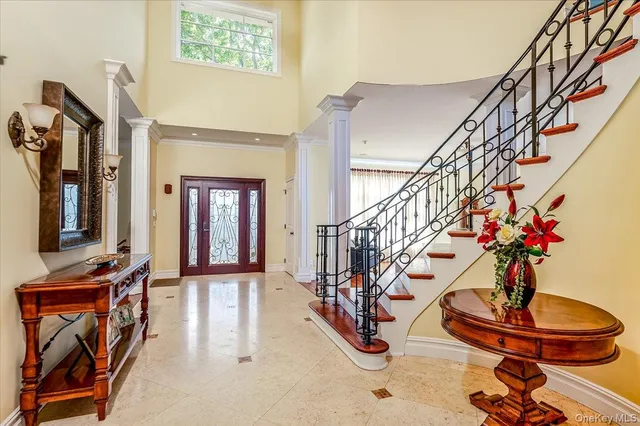 a dining room with wooden floor and a chandelier