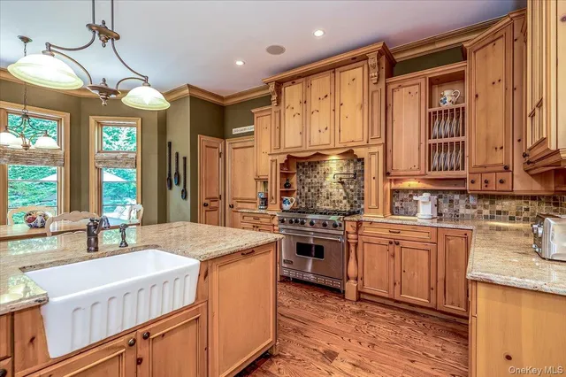 a dining room with furniture a chandelier and wooden floor