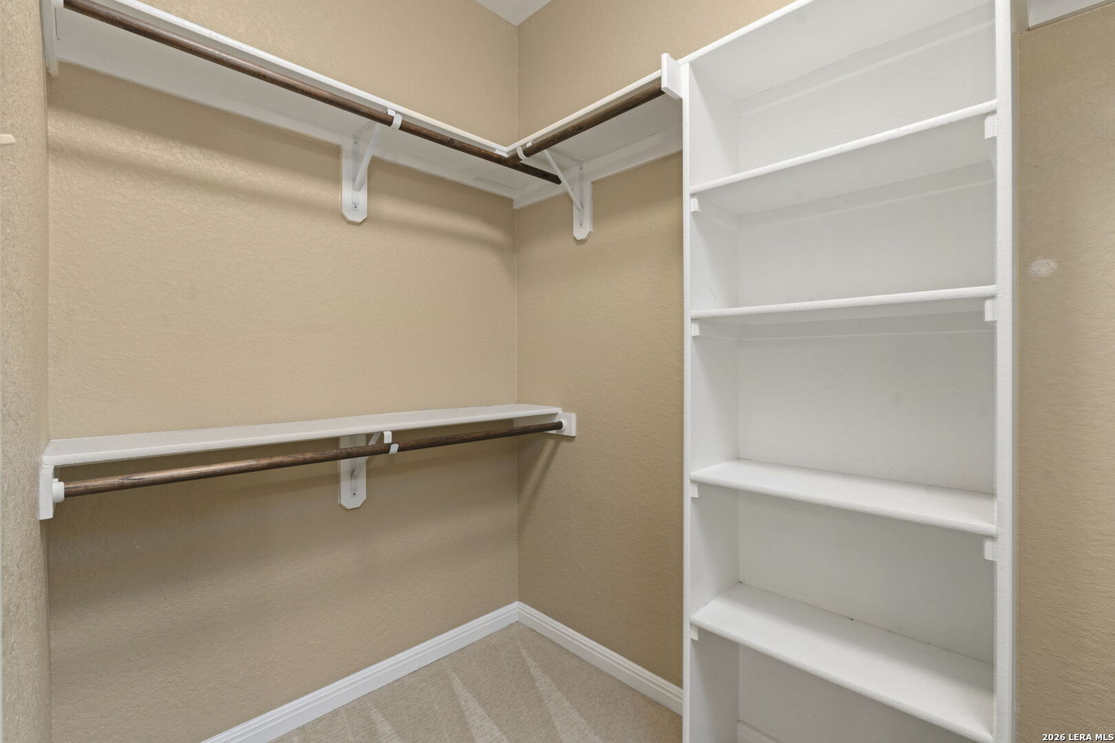 162 Lost Maples Way Marion, TX 78124 - Photo 11 of 18 a view of walk in closet with empty racks