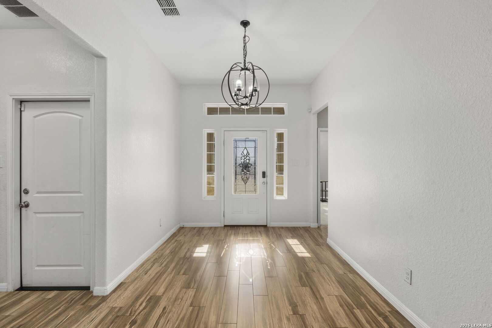 162 Lost Maples Way Marion, TX 78124 - Photo 2 of 18 a view of a hallway with wooden floor and a window