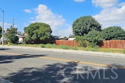 112 Merrill Street Corona, CA 92882 - Photo 8 of 11 a view of a yard with plants and wooden fence