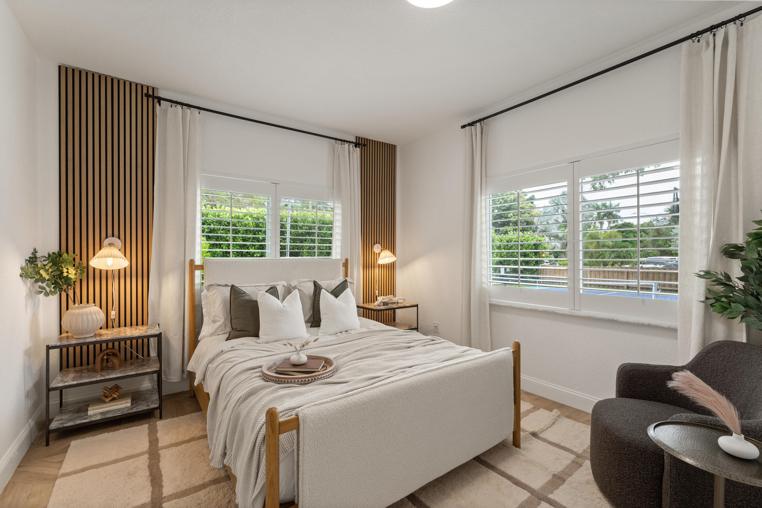 921 Ortega Road West Palm Beach, FL 33405 - Photo 24 of 60 a bedroom with a bed and large windows
