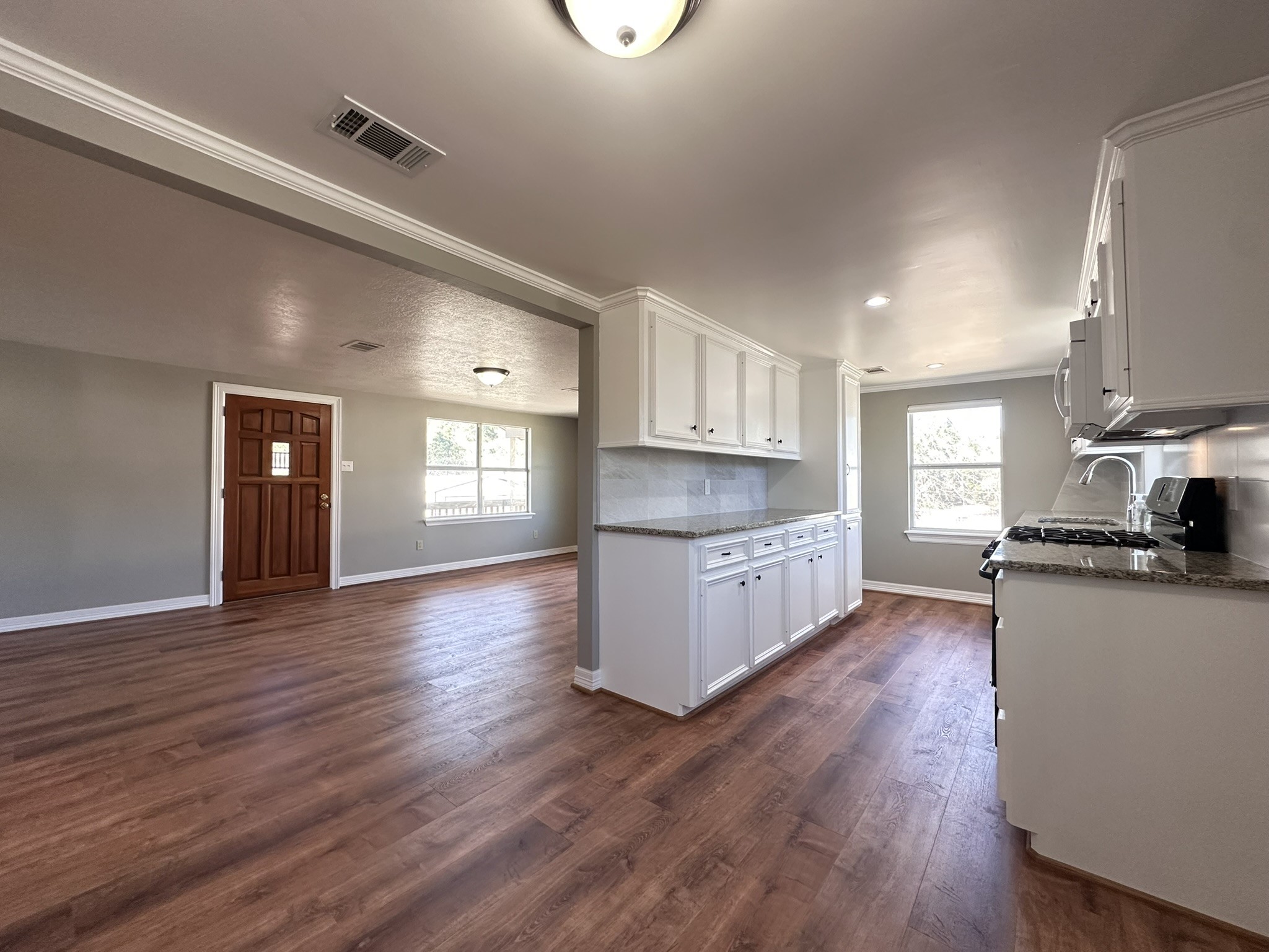 13868 Cedar Hill Road Montgomery, TX 77356 - Photo 5 of 19 a kitchen with stainless steel appliances granite countertop a sink cabinets and wooden floor