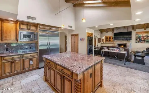 a kitchen with stainless steel appliances granite countertop a sink and cabinets