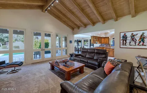 a living room with furniture a couch and large window