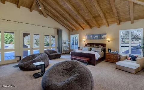 a bedroom with furniture and a large window