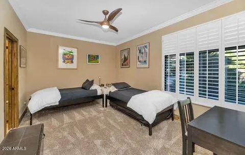 a bathroom with a granite countertop toilet sink and mirror