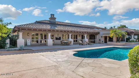 a view of a patio with table and chairs and potted plants