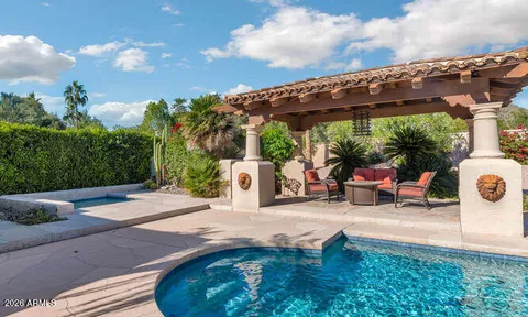 an aerial view of a house with garden space and a patio
