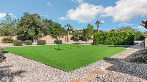 an aerial view of multiple houses with yard